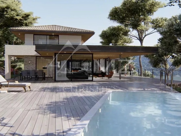 Vue d'une villa moderne avec piscine à débordement et terrasse au Lavandou.
