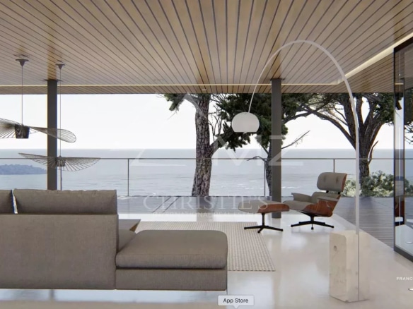Intérieur moderne avec vue sur la mer, salon lumineux et mobilier contemporain.