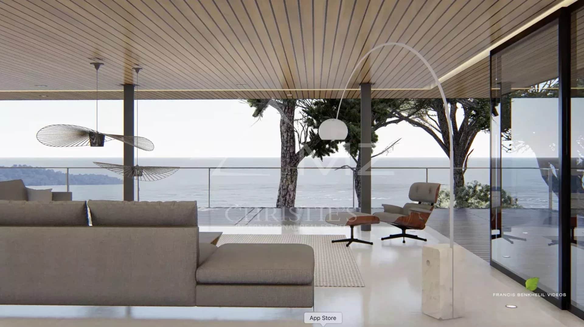 Intérieur moderne avec vue sur la mer, salon lumineux et mobilier contemporain.