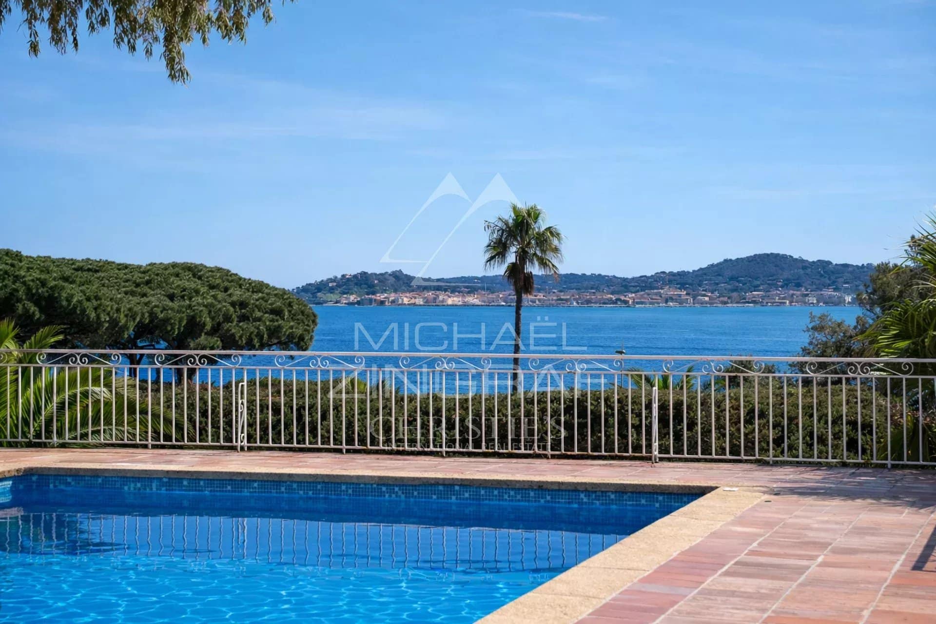 Vue sur la mer depuis une piscine avec palmiers à Beauvallon, Grimaud.