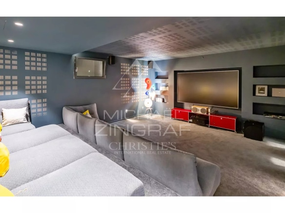 Interior of a contemporary villa with a living room and a television screen.