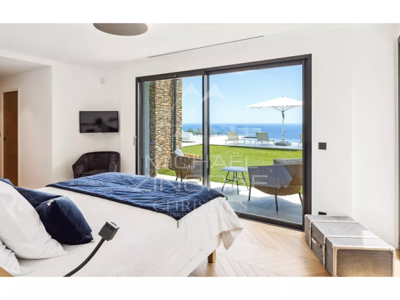 Modern room with sea view, access to an outdoor terrace.