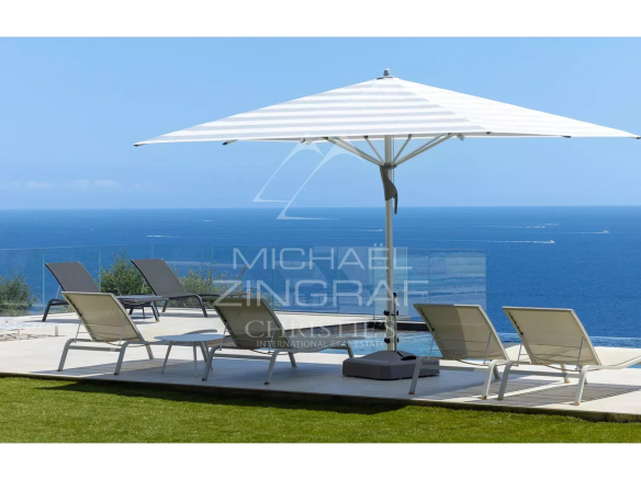 Terrace with sun loungers and parasol, sea view from Les Issambres.