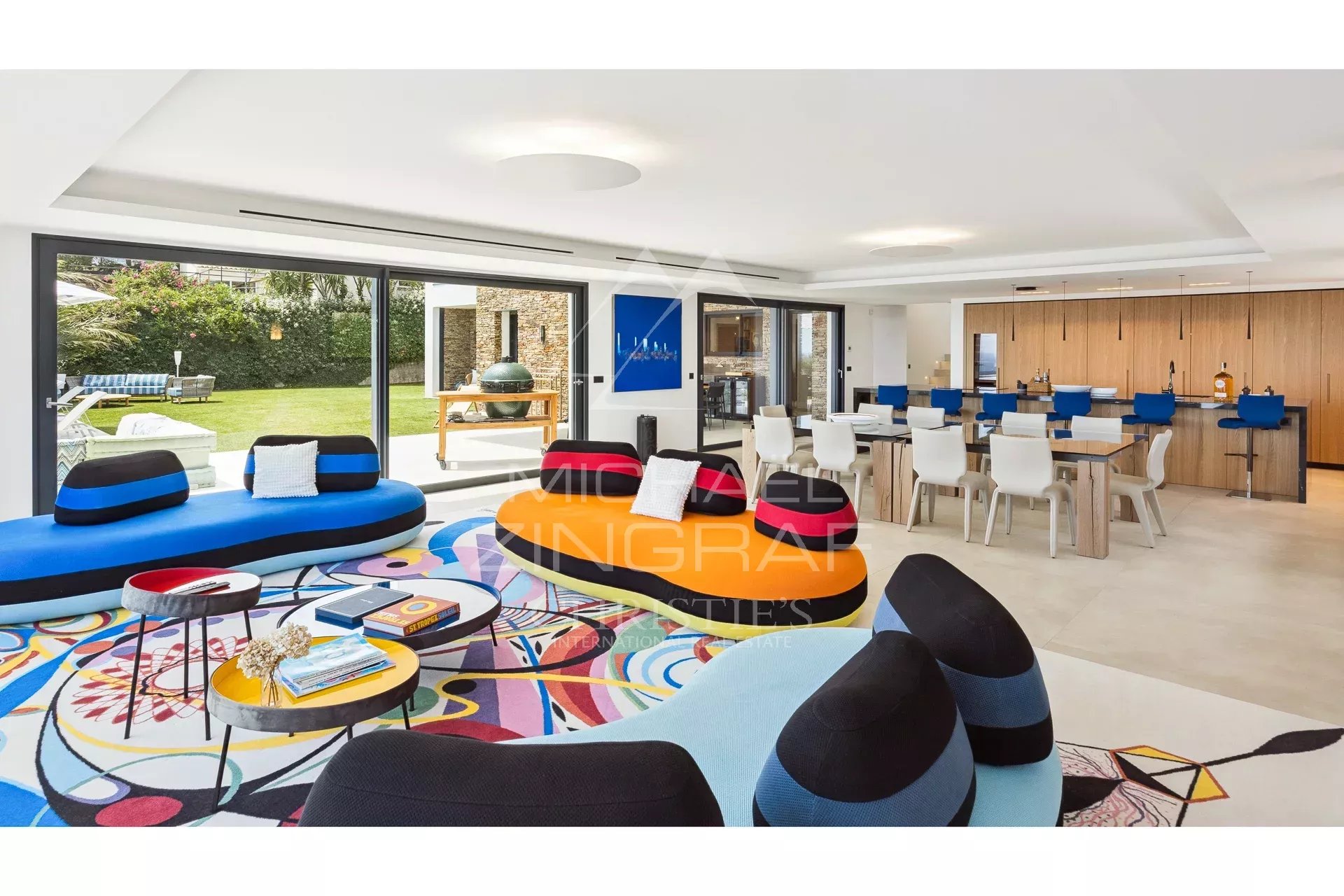 Modern interior of a villa with colorful living room and open kitchen.