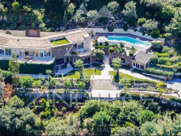 Aerial view of a modern villa with swimming pool and landscaped grounds in Saint-Tropez.
