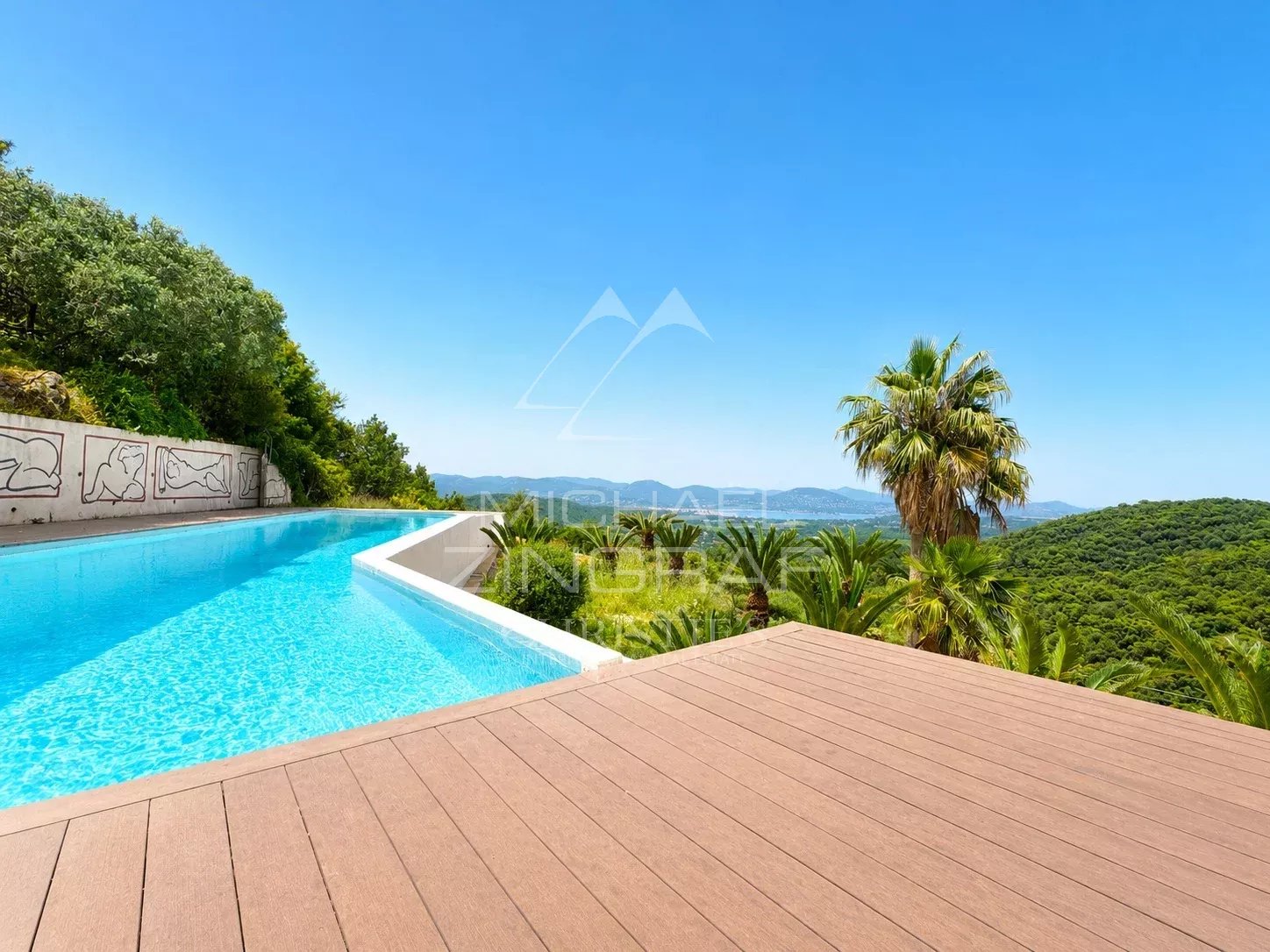 Exceptional villa in Saint-Tropez View of an infinity pool with a green landscape in the background.
