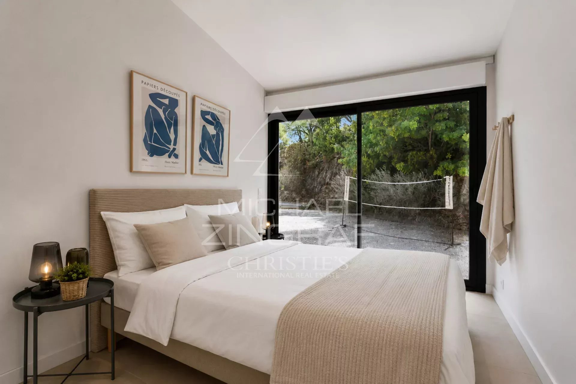 Chambre d'une villa moderne à Sainte-Maxime avec fenêtres donnant sur la nature.
