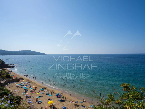 Plage de Gigaro avec des parasols et des baigneurs, vue sur la mer Méditerranée.