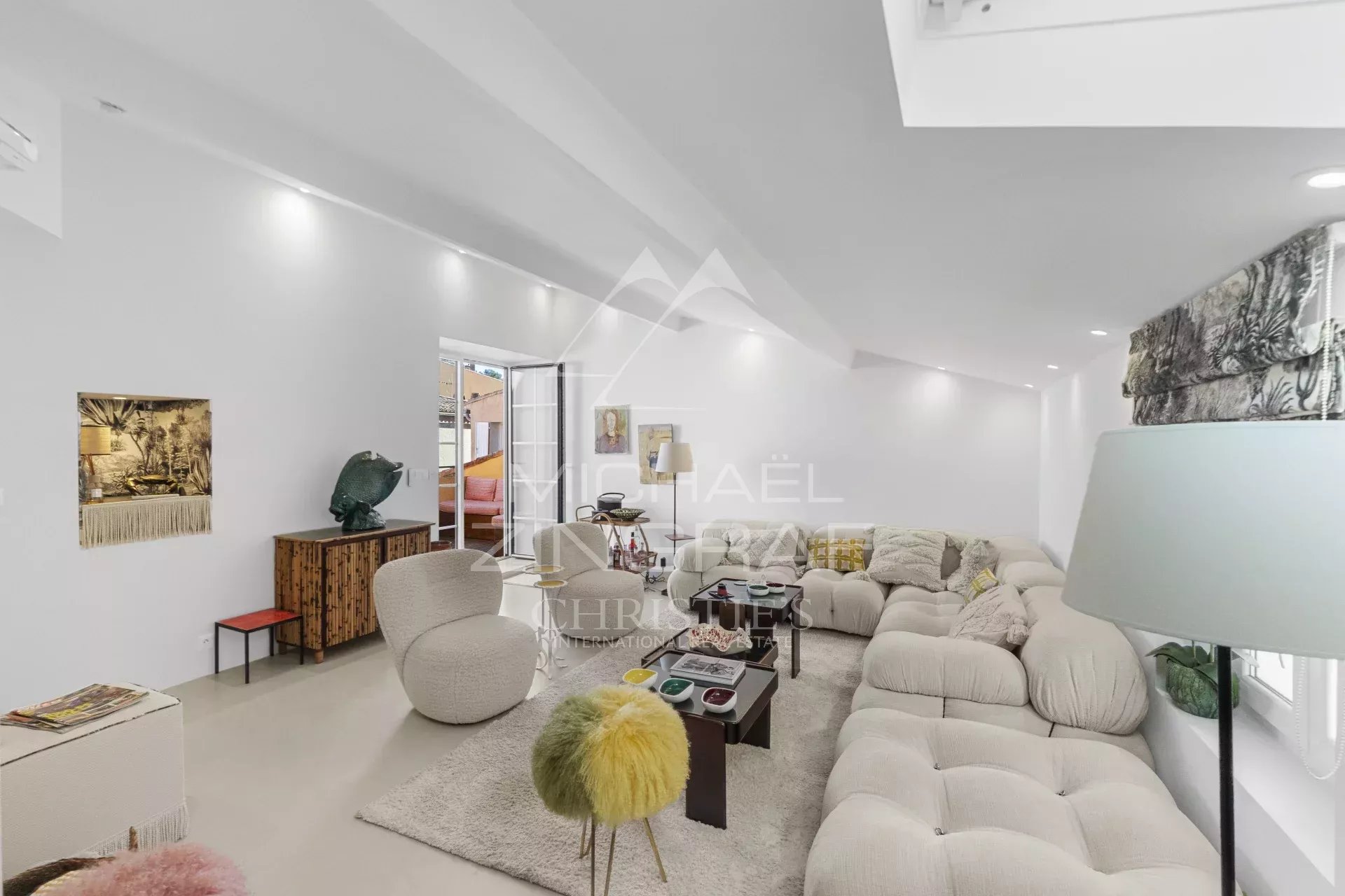 Duplex rénové à Saint-Tropez Intérieur d'un duplex rénové à Saint-Tropez avec salon lumineux et décoration moderne.