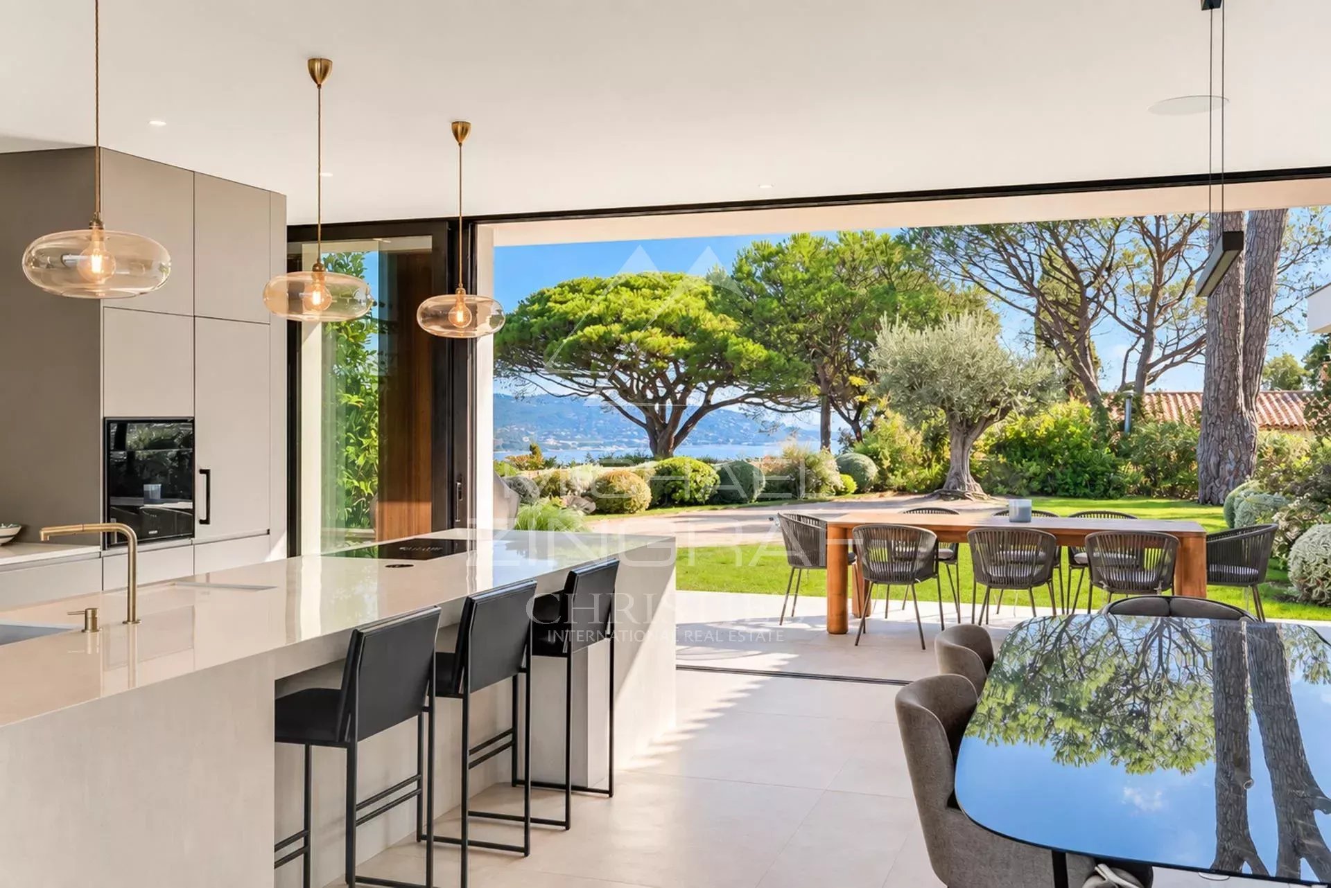 Interior of a contemporary villa in Sainte-Maxime Interior of a contemporary villa with modern kitchen and views of the garden and the Gulf of Saint-Tropez.