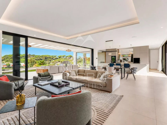 Interior of a contemporary villa with views of the landscape, modern and bright living room.