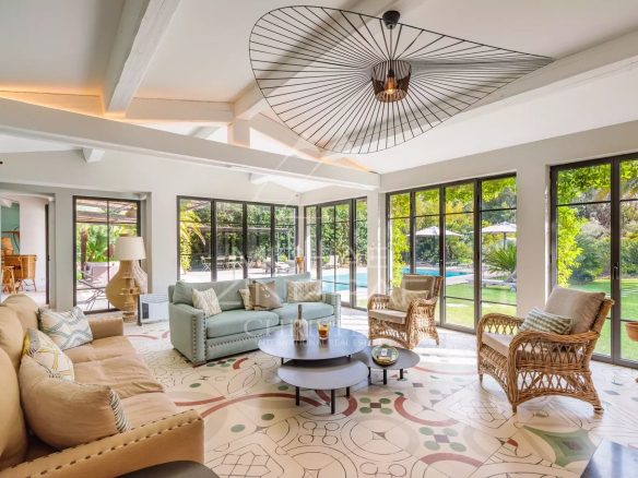Interior of a Provençal property with a bright living room and garden view.