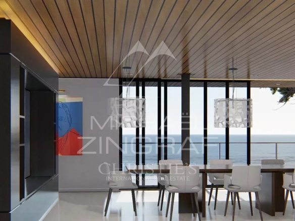 Intérieur moderne d'une propriété avec vue sur la mer, table à manger et grandes fenêtres.