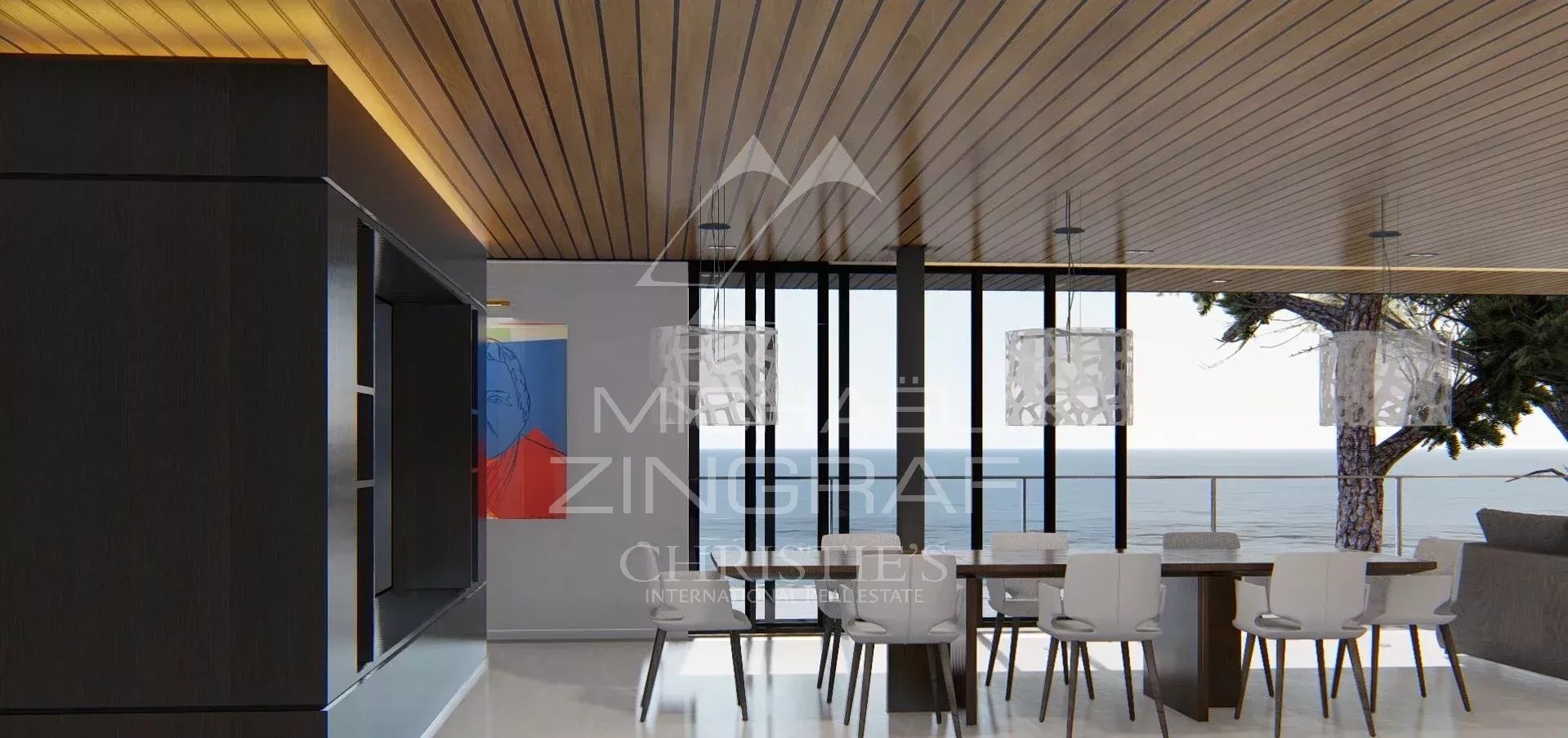 Intérieur d’une propriété au Lavandou Intérieur moderne d'une propriété avec vue sur la mer, table à manger et grandes fenêtres.