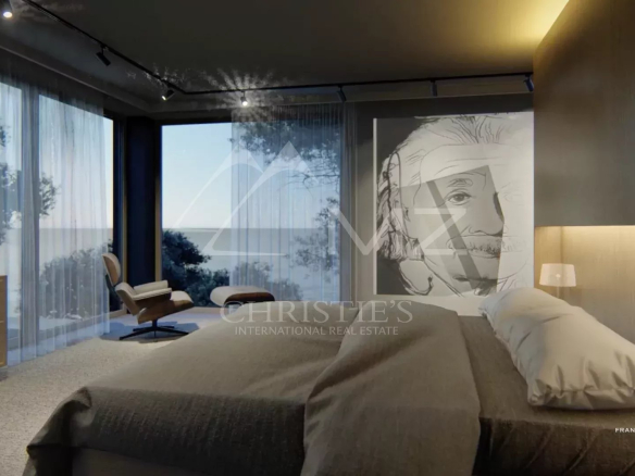 Chambre moderne avec vue sur la mer, décorée d'un portrait d'Einstein.