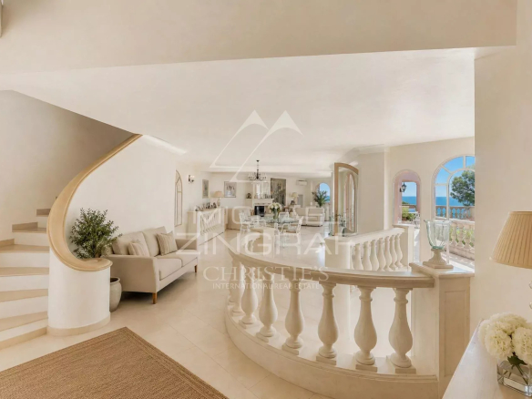 Interior of a luxury villa with a staircase and a bright living room in Sainte-Maxime.