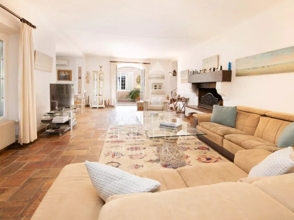 Interior of a spacious villa with a bright living room and tiled floor in Sainte-Maxime.