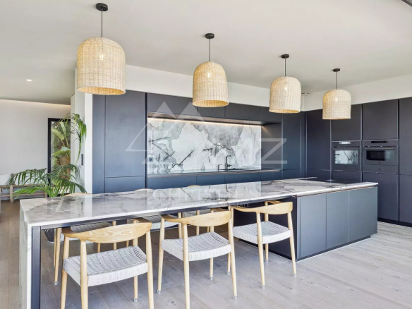 Modern kitchen with central island and wicker light fixtures, contemporary villa in Les Issambres.