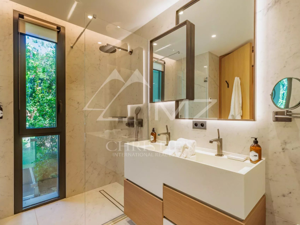 Modern bathroom with shower and sink in a villa in Ramatuelle