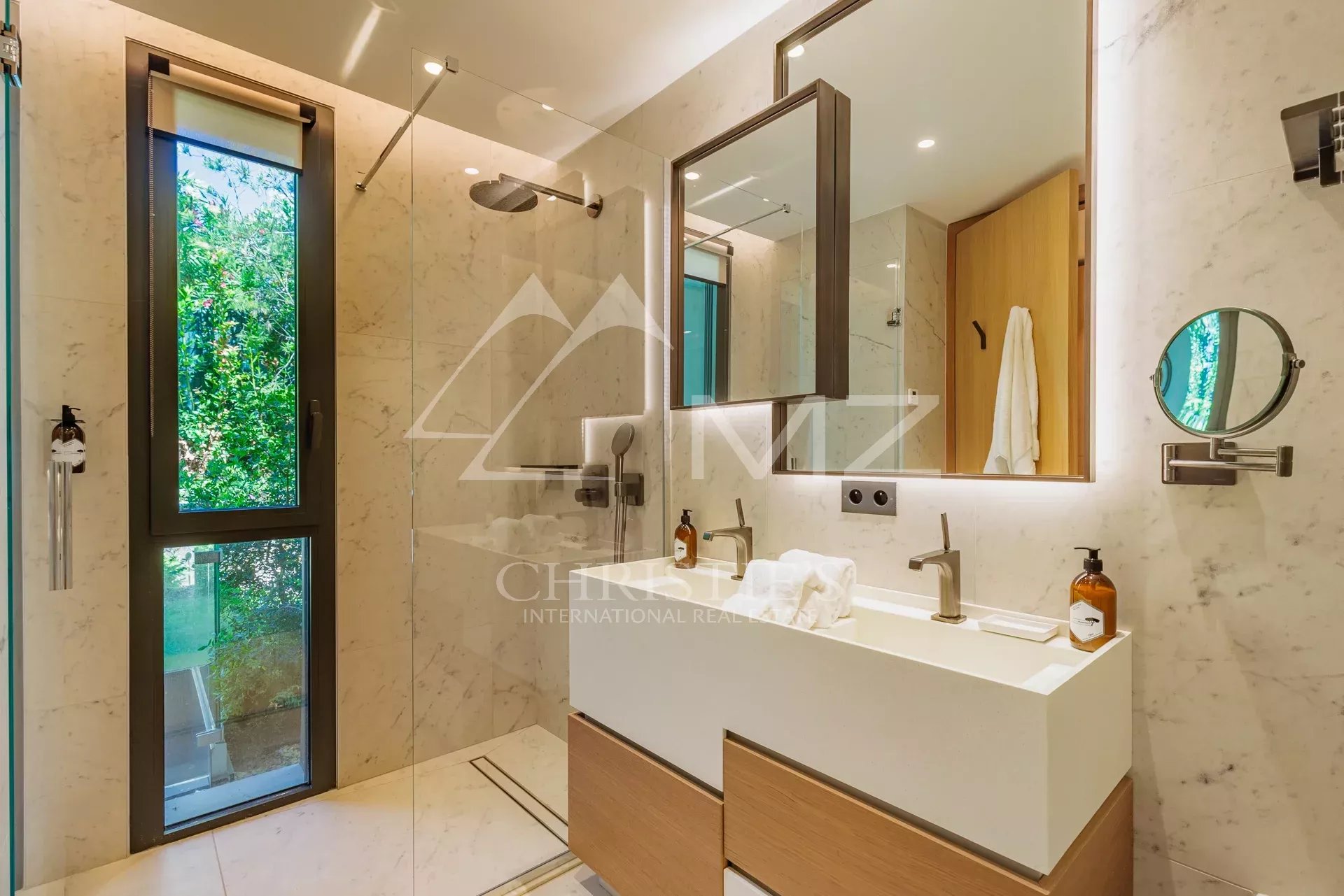 Modern bathroom with shower and sink in a villa in Ramatuelle