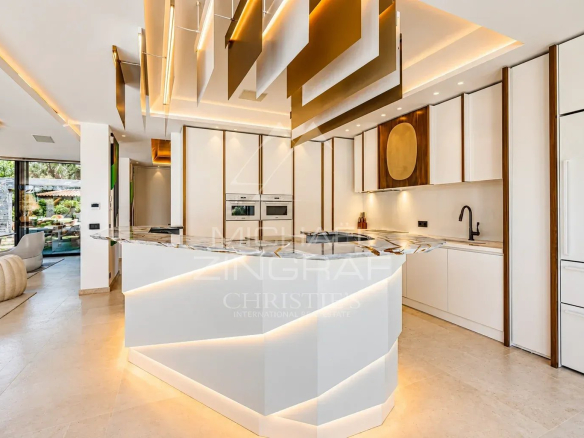 Modern interior of a villa with fitted kitchen and bright space in Ramatuelle.