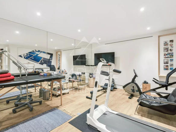 Salle de sport moderne avec équipements variés dans une villa contemporaine.