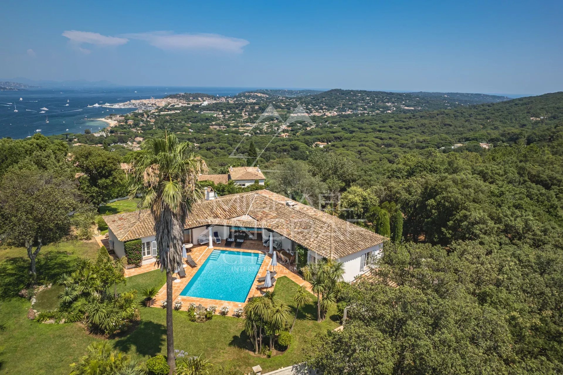 Property with sea view in Gassin Panoramic view of the sea and the villa with swimming pool in a landscaped garden in Gassin.