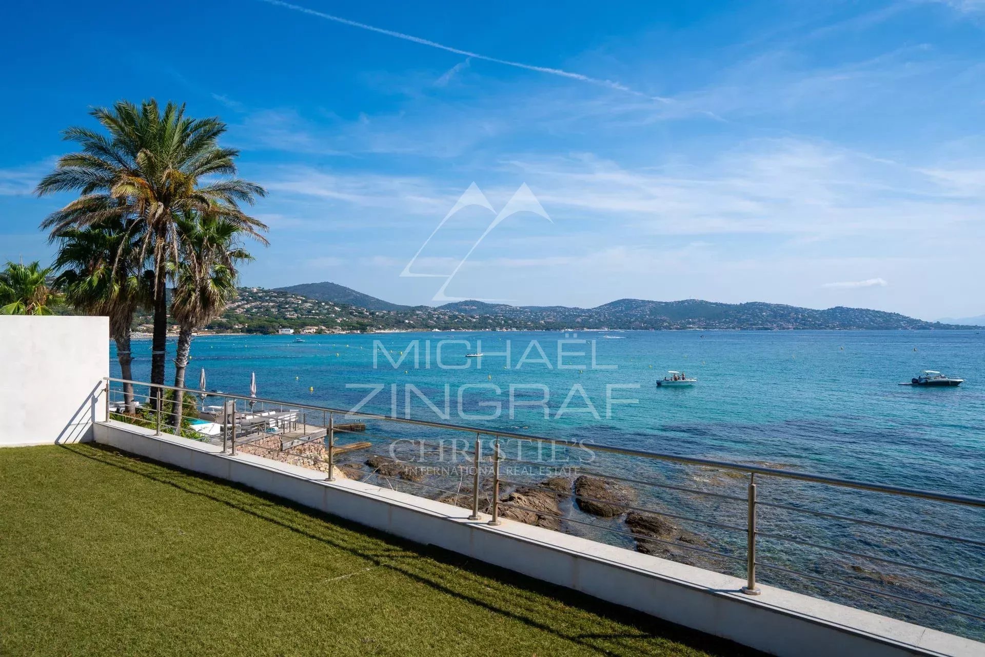 Waterfront villa in Sainte-Maxime Sea view from a villa in Sainte-Maxime with palm trees and boats in the distance.