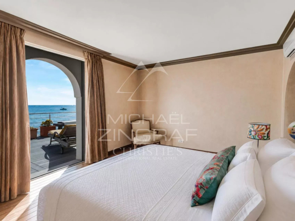 Room with sea view in Sainte-Maxime, decorated with white curtains and a white bed.