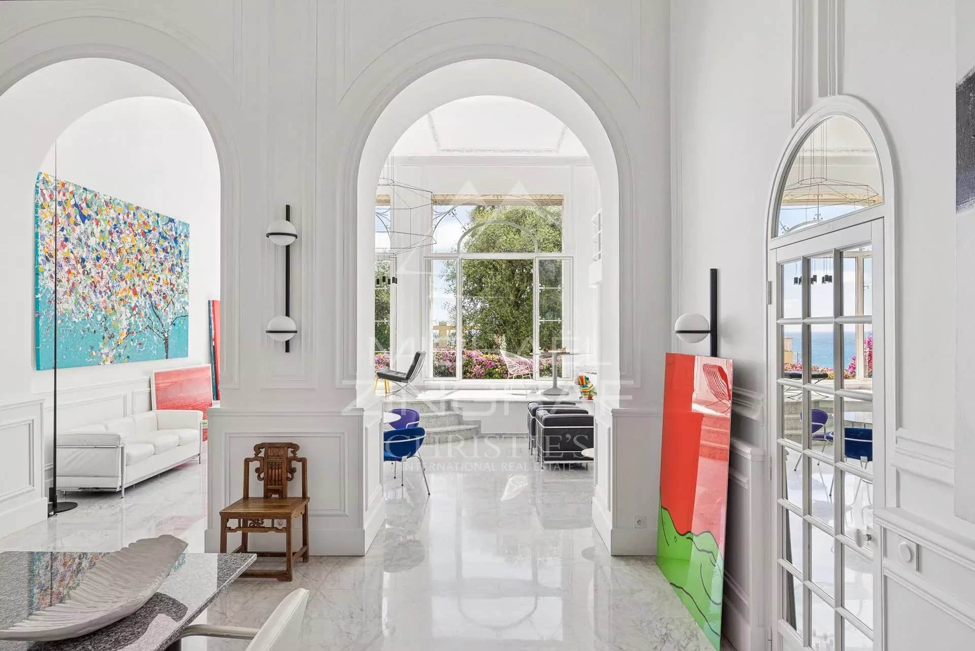Belle Époque apartment in Menton Interior of an elegant apartment with arches, colorful artwork and sea view in Menton.