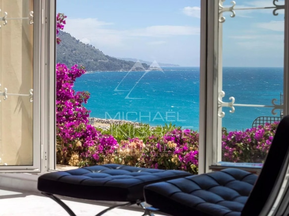 Sea view from an apartment with flowers in the foreground in Menton.