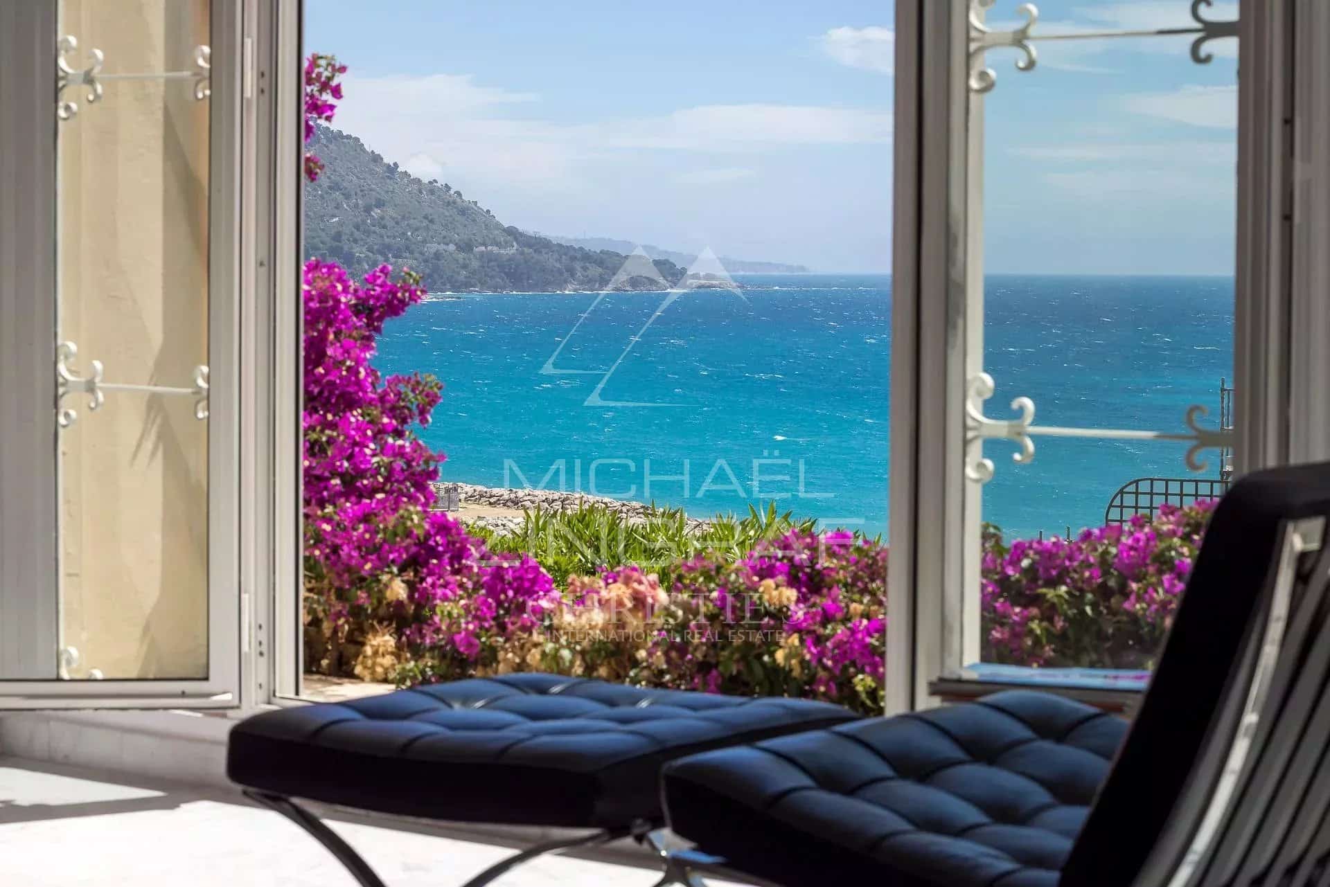 Exceptional apartment with sea view in Menton Sea view from an apartment with flowers in the foreground in Menton.