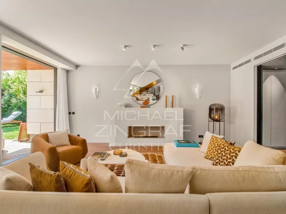 Interior of a contemporary villa with a bright living room and access to the outside.