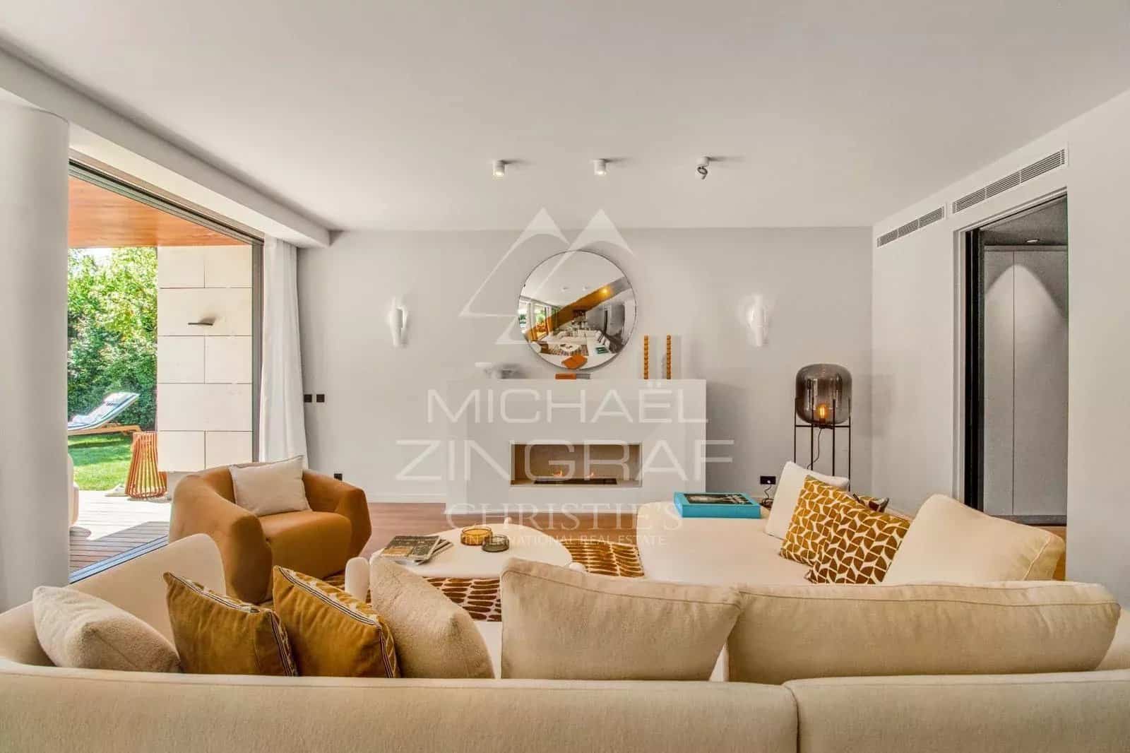 Interior of a contemporary villa with a bright living room and access to the outside.