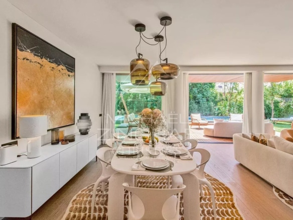 Interior of a contemporary villa with dining room and access to a garden.