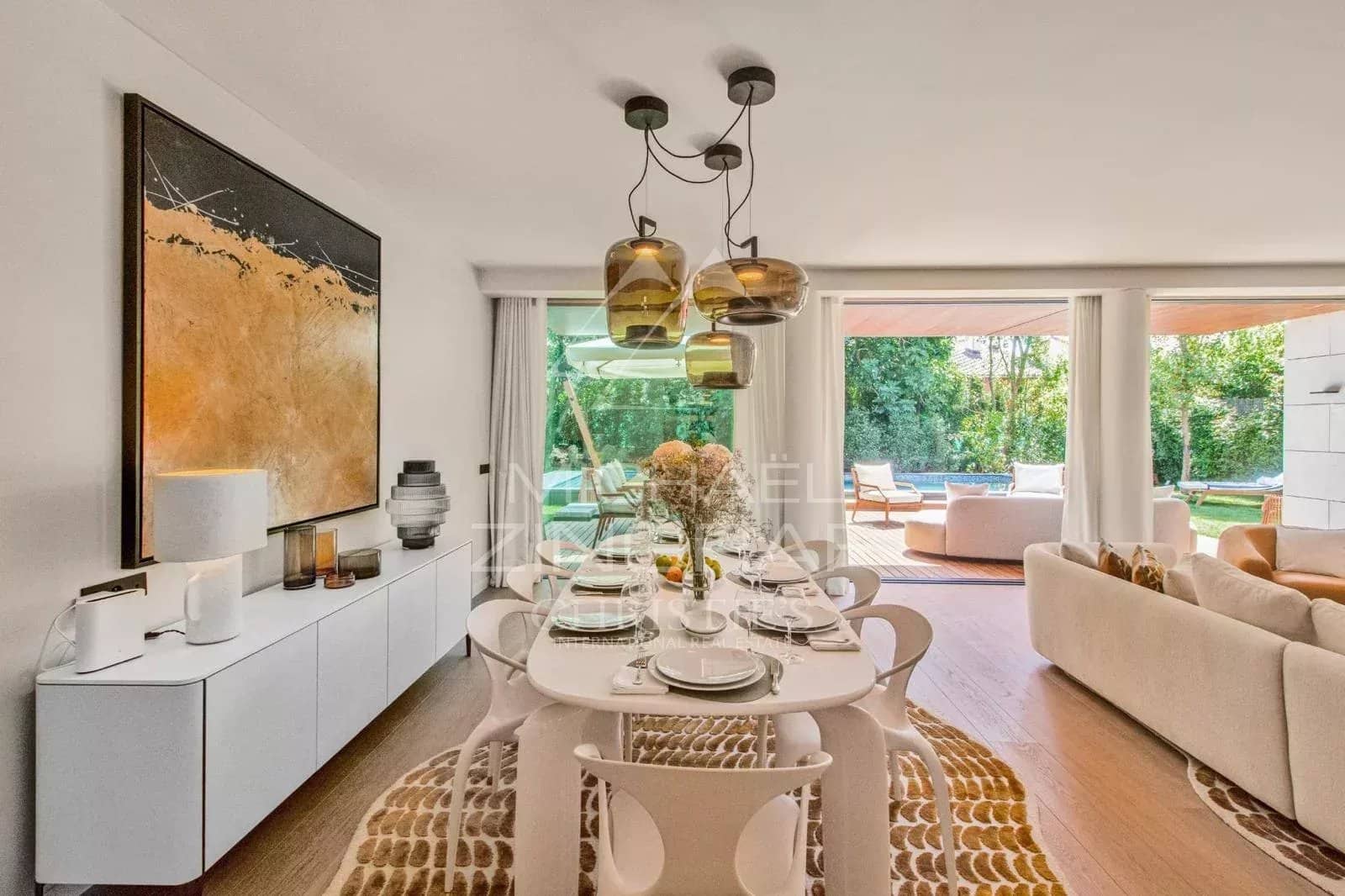 Interior of a contemporary villa with dining room and access to a garden.