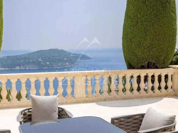 Terrasse avec vue sur la mer et Cap Ferrat, entourée de verdure.