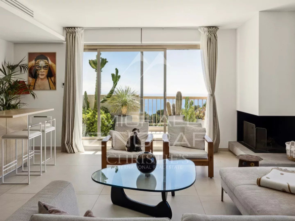 Intérieur d'un appartement moderne avec salon lumineux et vue sur la mer à Èze.