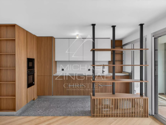 Modern kitchen in a renovated apartment in Villefranche-sur-Mer, with wooden furniture and modern appliances.