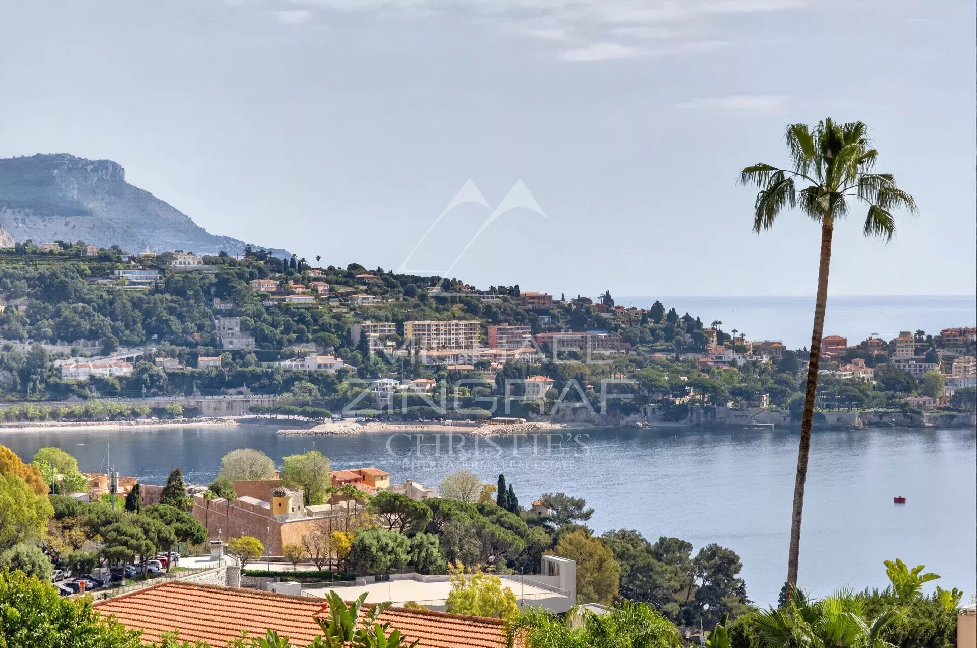 View of Villefranche-sur-Mer Panoramic view of Villefranche-sur-Mer with sea and mountains in the background.