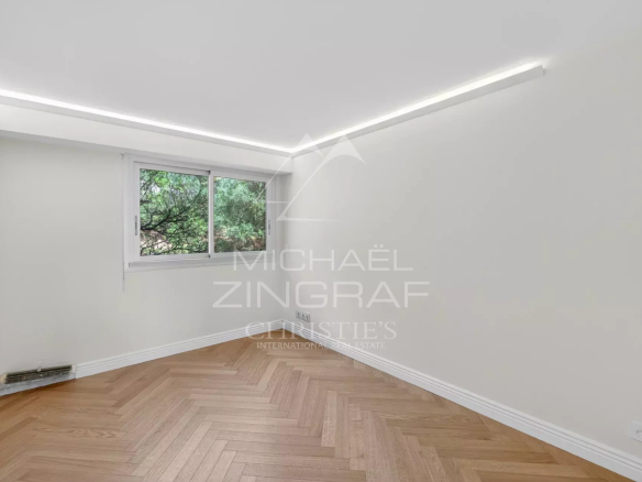 Interior of a renovated apartment with parquet flooring and windows, Villefranche-sur-Mer.