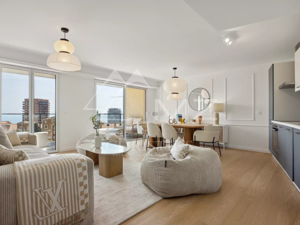 Interior of a modern apartment with sea view, bright living room and dining area.