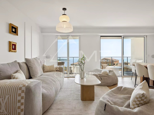 Interior of a modern apartment with sea view, bright living room and contemporary furniture.