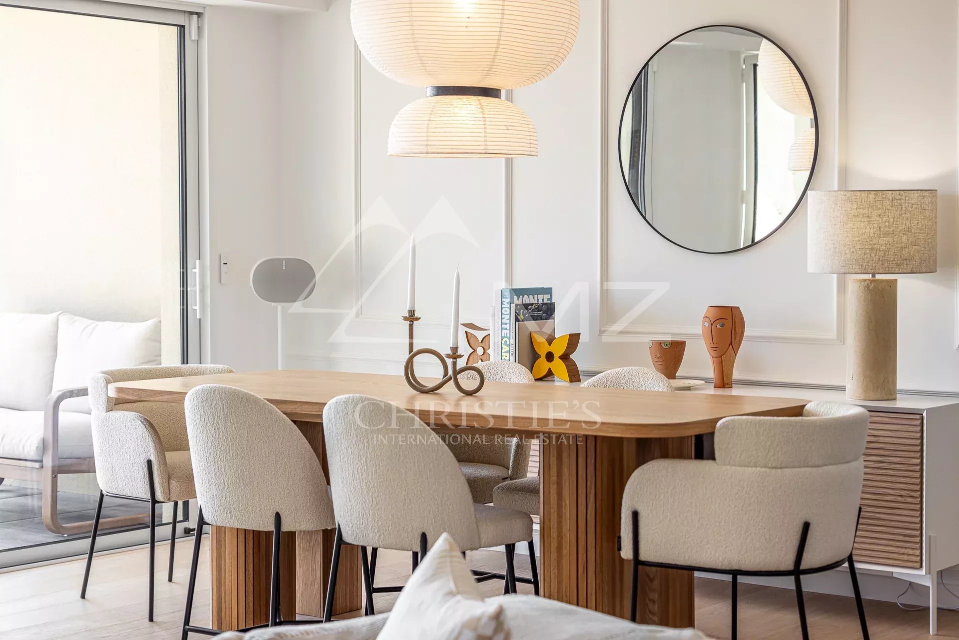 Modern apartment in Beausoleil Interior of a modern apartment with a dining table and chairs, elegant decor.
