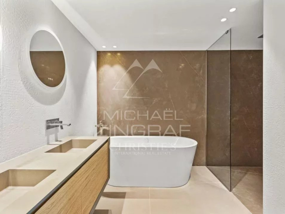 Modern bathroom with bathtub and sinks in an apartment in Cap d'Ail.