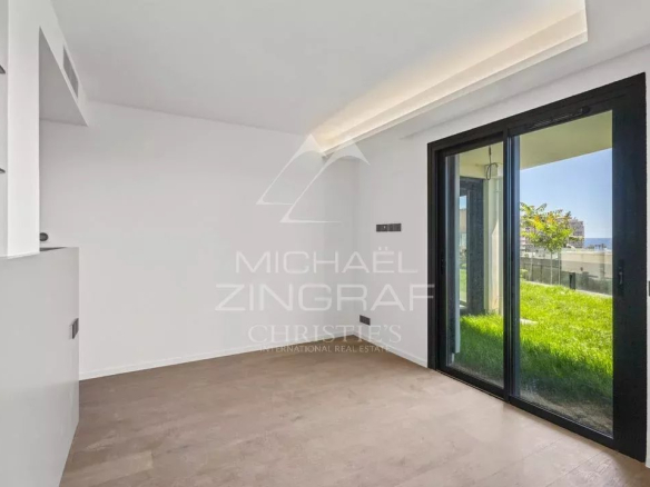 Interior of a new apartment in Cap d'Ail with a view of a private garden.