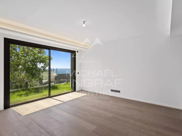 Interior of a new apartment in Cap d'Ail with views of the garden and the sea.