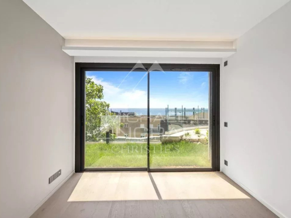 Interior of a new apartment with large bay windows overlooking a garden in Cap d'Ail.