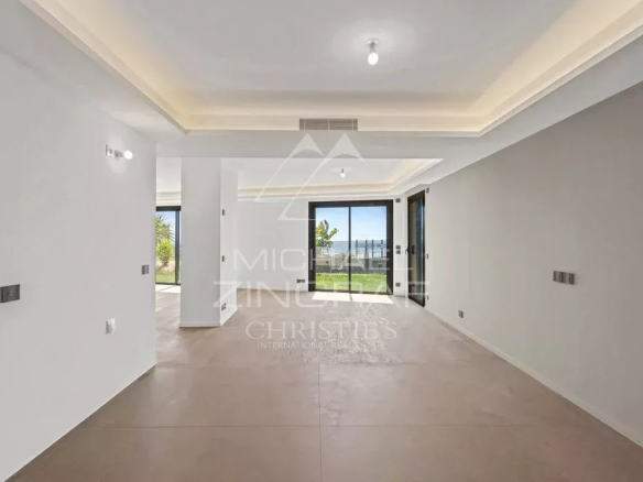 Interior of a new apartment in Cap d'Ail, bright space with light walls and large windows.