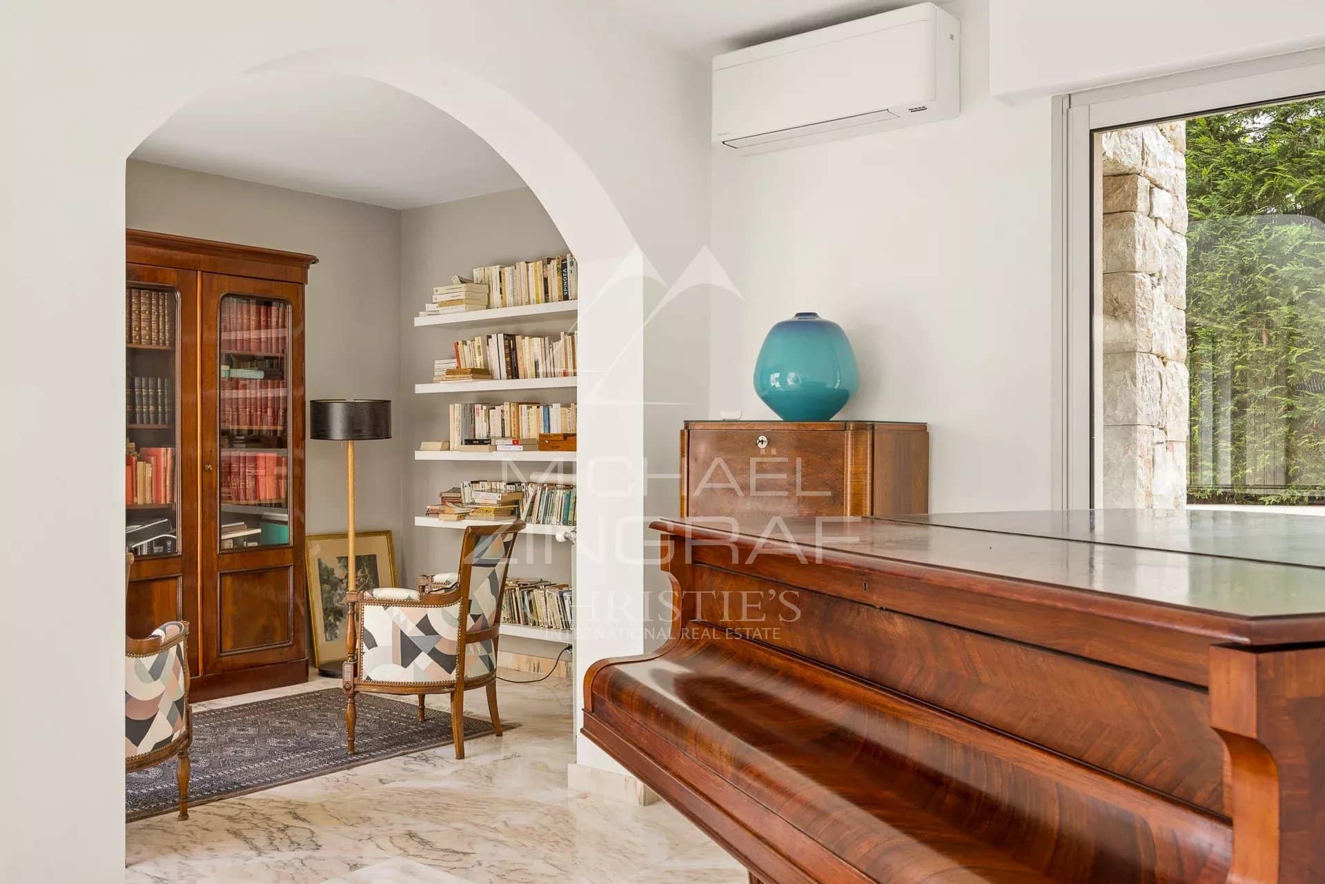 Intérieur d’une villa au Cap d’Antibes Intérieur d'une villa au Cap d'Antibes avec un piano, des étagères et un coin lecture